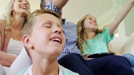 happy family watching television together in living room