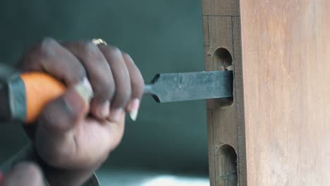 close up of carpenter chiselling a door