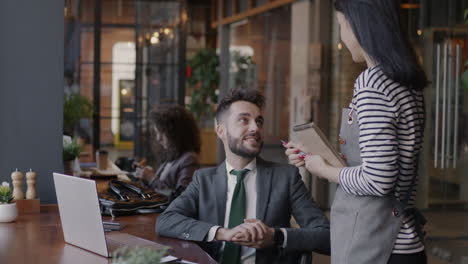 businessman ordering food at a modern cafe
