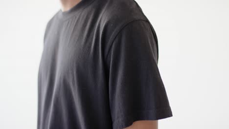 Midsection-of-african-american-man-wearing-black-t-shirt-with-copy-space-on-white-background