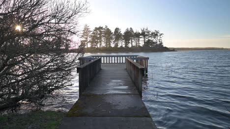 static shot of fishing pier on garrison lake during golden hour