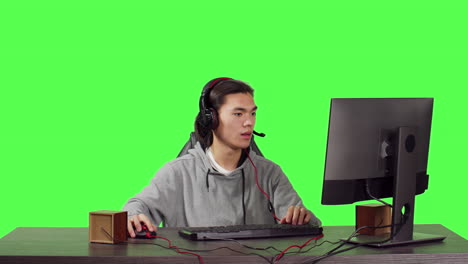 Young-gamer-sitting-at-computer-desk