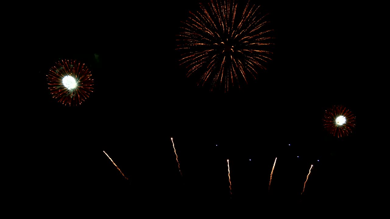 4K. seamless loop of real colorful fireworks festival in the sky display at night during national holiday, new year party or celebration event