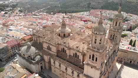 Spain-Jaen-Cathedral,-Catedral-de-Jaen,-flying-shoots-of-this-old-church-with-a-drone-at-4k-24fps-using-a-ND-filter-also-it-can-be-seen-the-old-town-of-Jaen