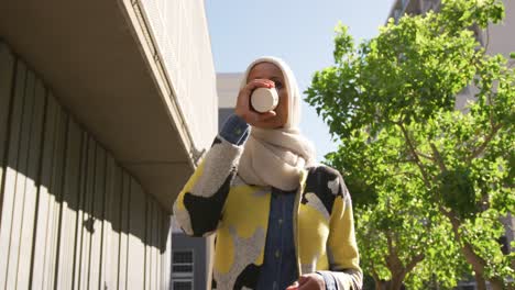 young woman wearing hijab out and about in the city