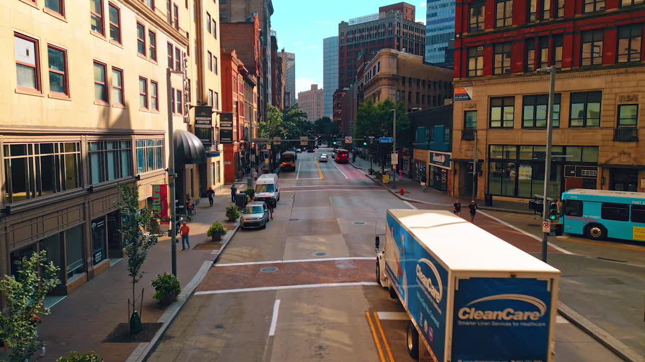 Pittsburgh, USA, 2 August 2025: Beautiful street of modern Pittsburg, Pennsylvania, USA at daytime. People walk by the sidewalks and cars go by the road. Aerial view