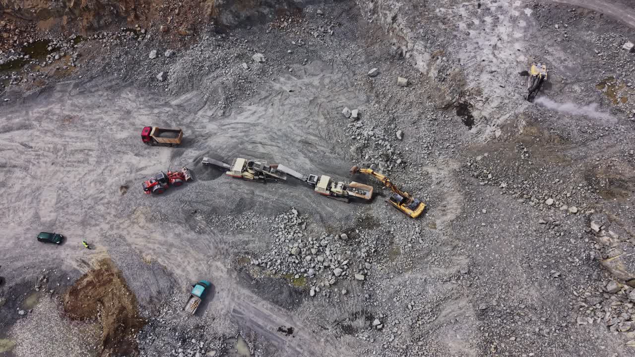 Aerial View of Heavy Machinery Working in a Rock Quarry