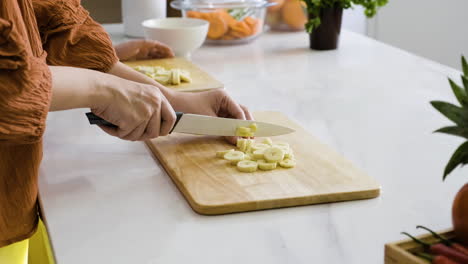 mom and boy cutting bananas.