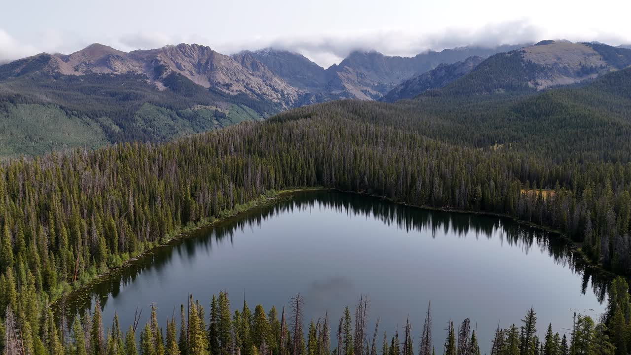 Aerial View of Alpine Lake in Pine Forest Under Mountain Hills. Lost Lake, Colorado USA