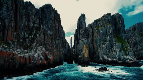 cape hauy drone flys at sea level towards cliffs in tasmania, australia 2