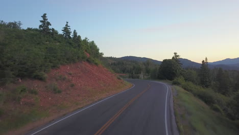 drone fly low over cinematic road in nebo loop, utah beautiful sunset