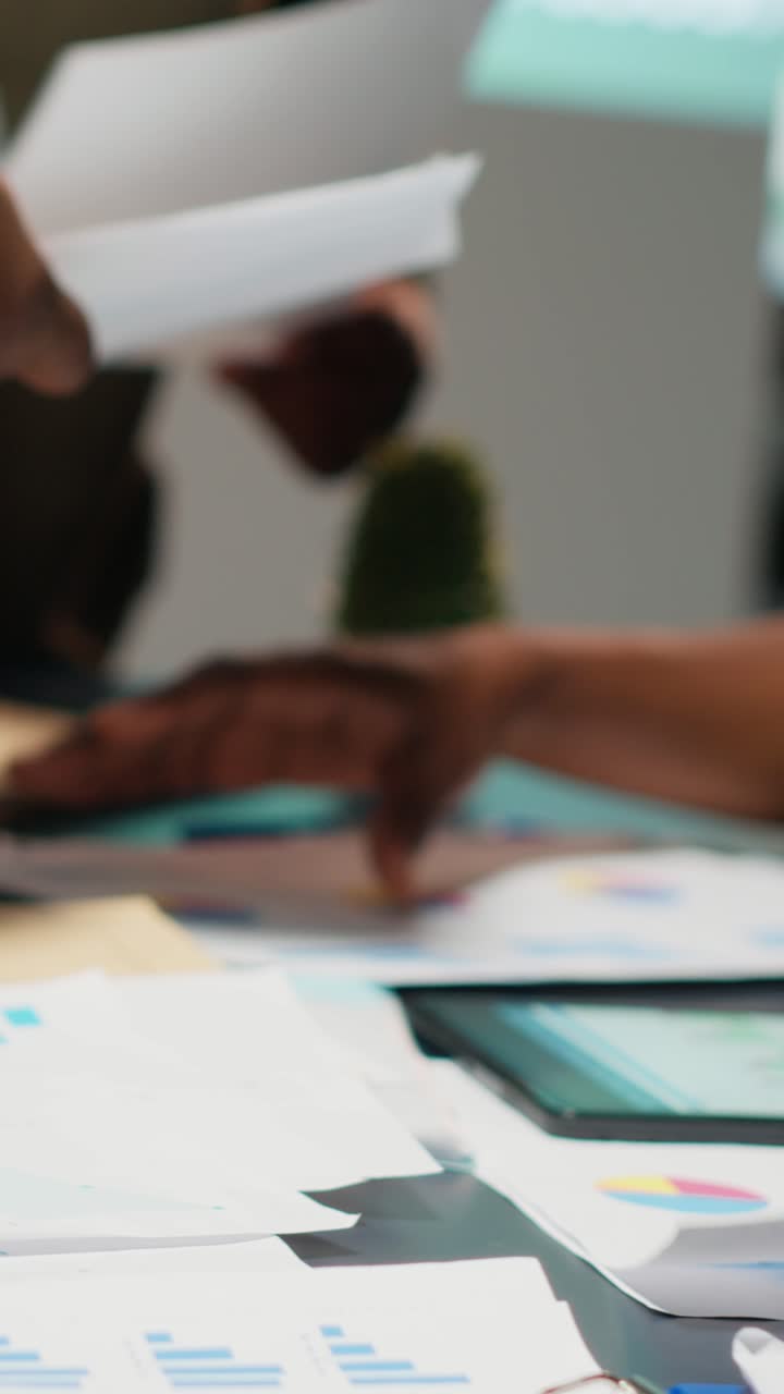 Vertical Video Business consultants team meeting after hours to review diagrams