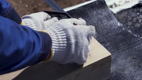 construction worker measuring and marking wood