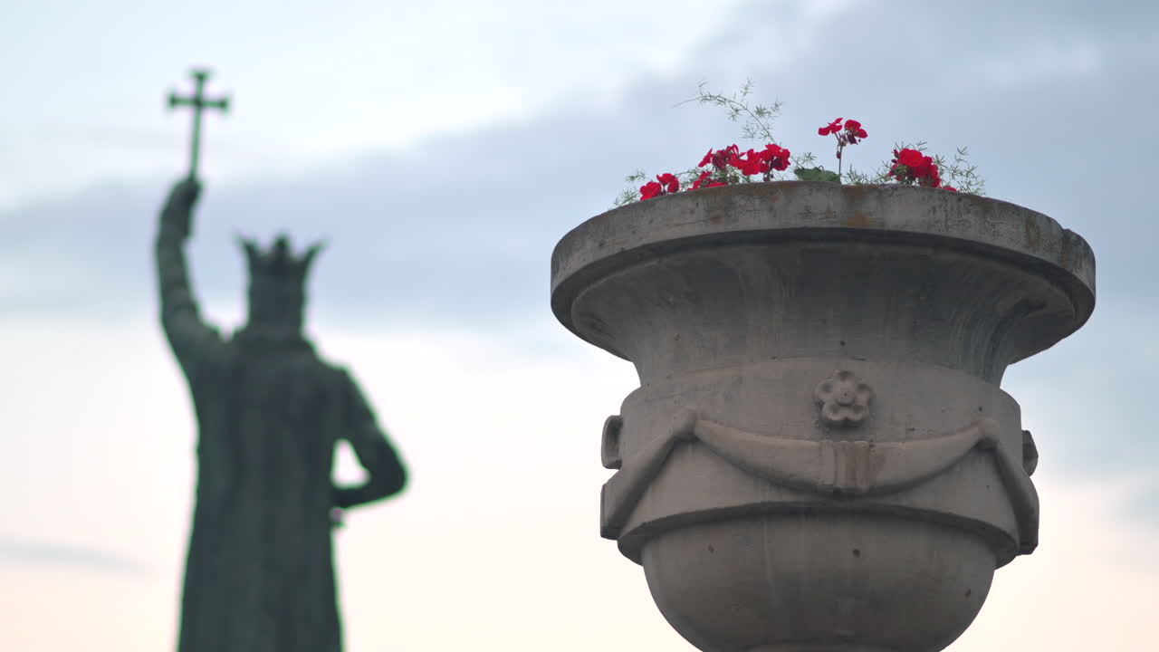 Chisinau, Moldova - June 5, 2021: Close up of an outside flower pot in the city centre with the Stephen the Great Monument on the background