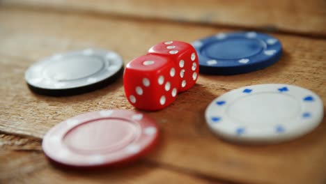 casino chips and dice on wooden table in casino 4k