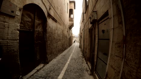 children walk on narrow ancient street paved with stones in urfa antique town of prophets