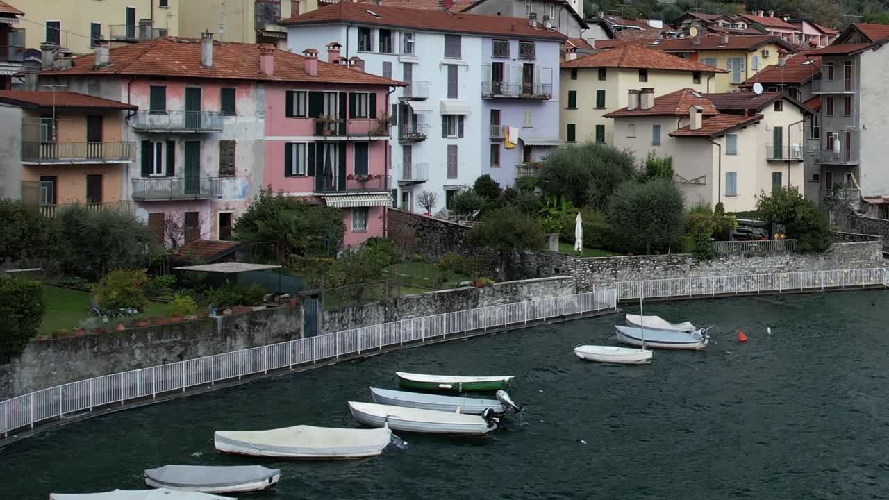 Aerial view of colorful houses by the water in the Italian Alps