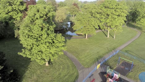 Empty-public-park-playground-aerial-view-above-quarantine-corona-covid-virus-lake-trees-area