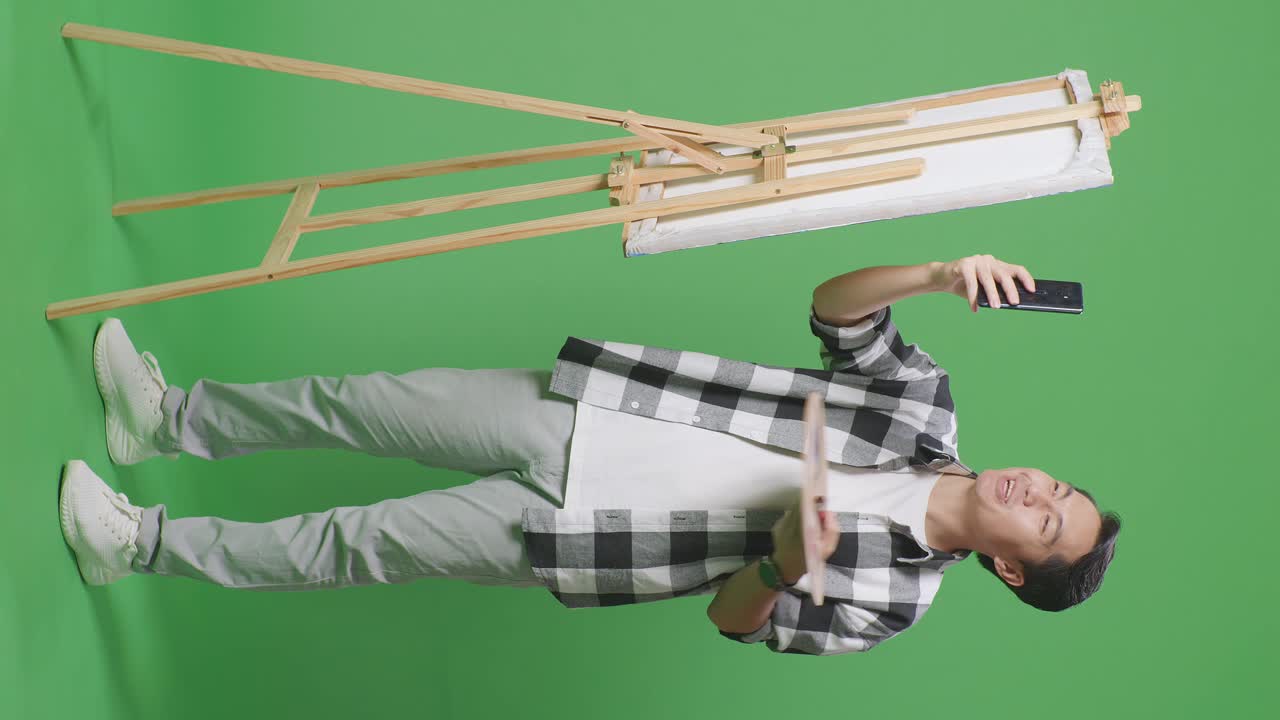 그의 그림의 사진을 찍는 남자