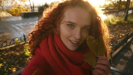 Beautiful-Young-Woman-With-Long-Curly-Hair-Closed-Eye-With-Autumn-Leaf