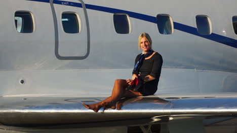 slomo: a playful flight attendant walks on the wing of an aircraft