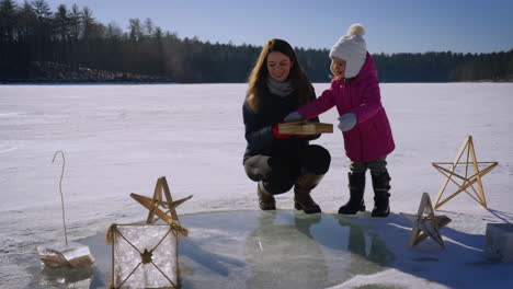 mother and child on a frozen lake