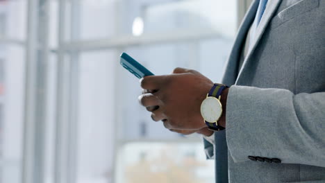 Hands-of-man,-typing-with-phone-in-office