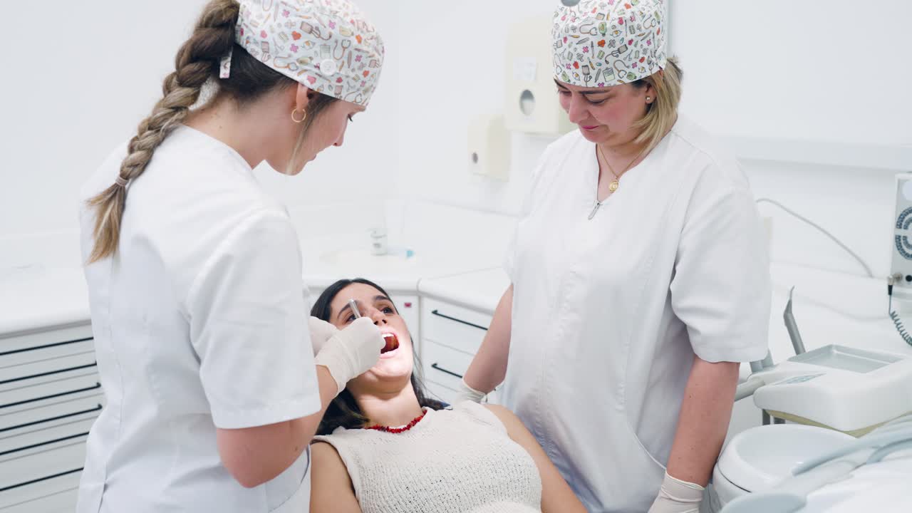 Dental procedure in a clinic with dentists and a patient