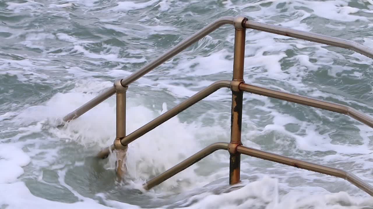 Railings and steps engulfed by a high tide