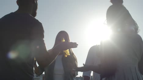 relaxed people dancing with beer bottles