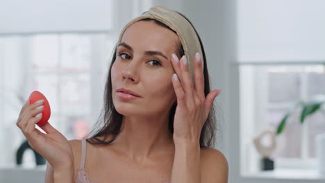 Pov-morning-lady-makeup-routine-at-bathroom.-Woman-holding-visage-beauty-blender