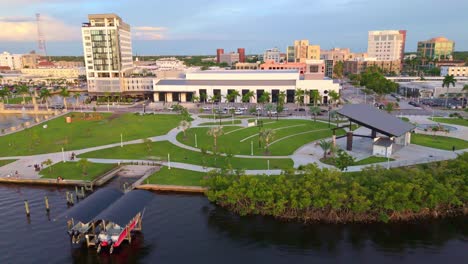 aerial view of caloosa sound amphitheater and park at shore promenade of fort myers, florida. sunset time in tropical town of usa. wide shot. orbit. quiet atmosphere