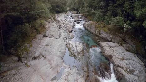 Drone-filming-over-the-mountain-river-and-fisherman-in-a-summer-morning