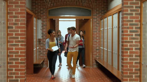 Students-walking-down-hallway-to-locker