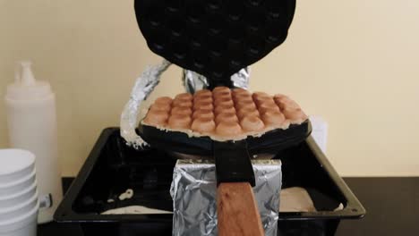 making waffle in a waffles making toaster