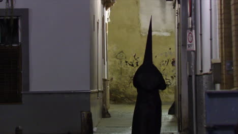 religious procession in a narrow alley at night
