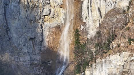 seerenbach falls' majestic cascade in switzerland - aerial ascend view