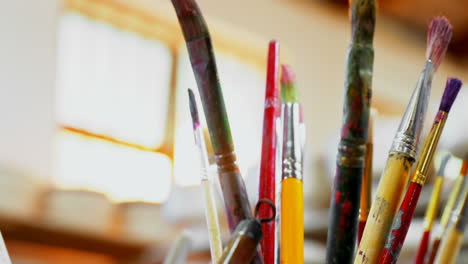 close-up of various paint brush in pencil holder 4k