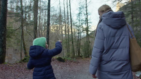 mother and daughter hiking in the autumn forest