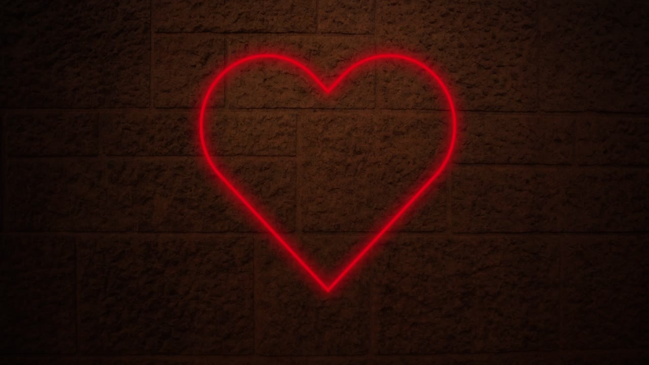 Insegna al neon a forma di cuore su muro di mattoni 4k