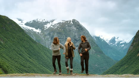 happy friends dancing in the norwegian mountains