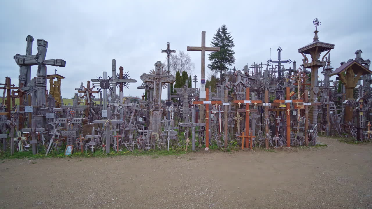Hill of crosses near Siauliai in Lithuania, aerial side fly view