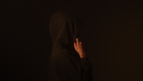 person wearing a hoodie in profile view
