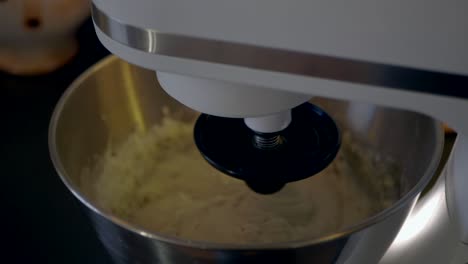 mixing the gluten free dough with the help of a kitchen assistent