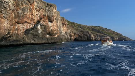 Touristic-boat-sailing-at-Punta-Meliso-southern-part-of-Italy-in-Apulia-region,-slow-motion