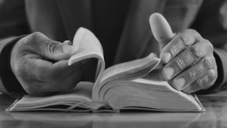 hands turning pages of a book