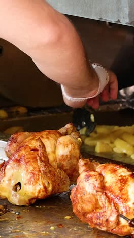 chicken and potatoes roasting in a rotisserie oven