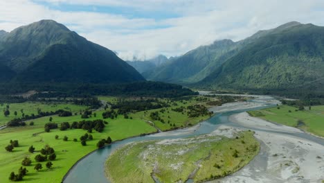 stunning aerial landscape view of braided river system winding through pristine mountainous terrain of southern alps in south island of new zealand aotearoa