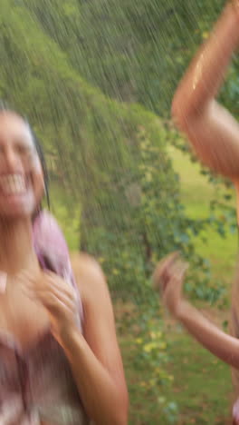 happy friends having fun with hose in the park