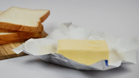 slice of a butter on a paper on table